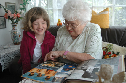 grandmother grand daughter looking at family pictures